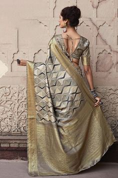 A playful colored saree with lots of drama. This saree is the element of style you have been looking for. With a splendid border, this is a sure-shot choice. This saree is a suitable amalgamation of style and grace that is required from an ethnic wear. The saree is ideal for any formal gathering. The saree comes with an unstitched blouse of corresponding color and design as shown in the picture. Fabric Type : Handloom SilkColor: GreyLength: 6.3 meters (including 85 cms blouse fabric) Blouse Fabr Bollywood Style Pre-draped Saree With Border For Eid, Semi-stitched Pre-draped Saree With Zari Weaving For Navratri, Navratri Pre-draped Saree With Border, Diwali Dola Silk Pre-draped Saree With Border, Diwali Pre-draped Saree With Zari Weaving, Bollywood Banarasi Silk Pre-draped Saree With Border, Gold Art Silk Pre-draped Saree With Border, Festive Banarasi Silk Pre-draped Saree With Border, Bollywood Style Saree With Border For Eid