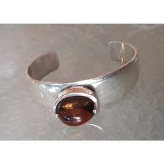 The Weight of this unique Designer Silverwork is 65 gr. Incl. the Stone This piece has an attribution mark,   I am sure that it is completely authentic and  take full responsibility for any authenticity   issues arising from misattribution Modern Brown Bracelets For Formal Occasion, Modernist Oval Jewelry For Formal Occasions, Classic Cabochon Bracelets As Gift, Modern Brown Gemstone Jewelry, Classic Cabochon Bracelets For Gifts, Adjustable Gemstone Bangle For Formal Occasions, Timeless Hallmarked Bangle As A Gift, Formal Gemstone Cuff Bracelet In Bangle Shape, Oval Gemstone Bangle For Formal Events