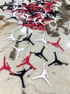 red and black air jordans are on the floor in front of a marble wall