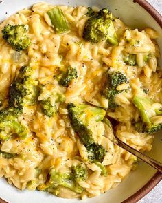 a white bowl filled with macaroni and broccoli