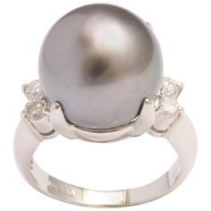 Platinum and 4 Diamond Ring giving an updated look to a traditional Pearl & Diamond Ring. Japanese made and centered on beautiful 13mm Grey South Sea Pearl with 2 round full cut stones on either side - totaling 25pts - just enough to brighten the Pearl - but not overpower it. Fits a size 6 3/4 but can be sized Pearl Diamond Ring, Pearl Cocktail Ring, South Sea Pearls Earrings, Cultured Pearl Ring, Pearl Earring Set, Green Sapphire Engagement, Cushion Cut Diamond Ring, Green Sapphire Engagement Ring, Radiant Cut Engagement Rings