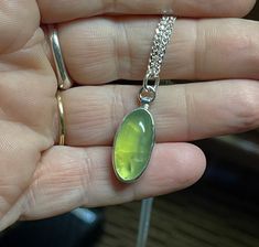 "A cool, green translucent Prehnite gemstone with natural inclusions is nestled in sterling silver and hangs from an 18\" sterling silver chain. Perfect everyday accessory. This one-of-a-kind necklace is ready to ship. Prehnite: 20 x 10mm Chain: 18\" Will arrive gift-boxed. My jewelry is handcrafted one piece at a time by me in my home studio in Portland, Oregon. If I can help you with any questions about this piece or any of my other products, please feel free to contact me: hello@paulla.com PI Green Prehnite Necklace For Gift, Green Round Pendant Gemstone For Gift, Gift Prehnite Gemstone Jewelry, Green Chrysoprase Oval Pendant Jewelry, Green Sterling Silver Oval Pendant Necklace, Green Spiritual Jewelry With Natural Inclusions, Spiritual Green Jewelry With Natural Inclusions, Unique Green Oval Necklaces, Chrysoprase Oval Pendant Necklace As Gift