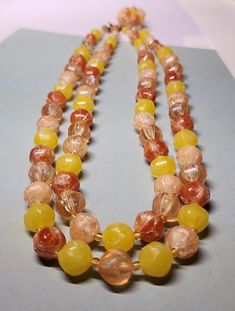 This is for vintage jewelry, double strand, orange and yellow, beaded necklace. This is signed Made in Western Germany with no other markings. This has not been cleaned, and has not been altered. This has normal wear and tear for the age. It has a nice weight, and in good condition for the age. The pictures are off in color sometimes and depict the true highlights. I took several pictures so you could see clearly the condition this is in. This is a used item and sold as is. If you have any questions, please contact me. I sell an item as is, so normally don't refund. This item has free shipping, and I do not ship international. Vintage Multicolor Double Strand Jewelry, Vintage Amber Jewelry With Colorful Beads, Vintage Multicolor Double Strand Beaded Necklace, Vintage Multi-strand Necklace With Large Beads, Vintage Orange Jewelry With Faceted Beads, Vintage Double Strand Beads For Jewelry Making, Vintage Multi-strand Beaded Necklace With Colorful Beads, Vintage Multi-strand Colorful Beaded Necklaces, Orange Vintage Jewelry With Faceted Beads