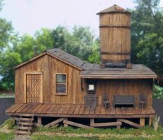 a small wooden building with a tower on top