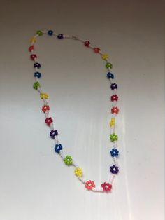 "Daisy Chain Necklaces/Flower Necklaces with multiple colour options available. If there is a pattern or colour palette you would like and do not see here, please do not hesitate to message! These daisy chain necklaces are the perfect accessory to add colour and class to any outfit. The necklaces are dainty and simple, but add a lovely pop of colour. Each necklace has a coordinating barrel clasp. With Spring and Summer around the corner, it is the perfect time to accessorize with a pretty daisy Trendy Multicolor Beaded Flower Necklace, Trendy Multicolor Flower Necklace With Colorful Beads, Trendy Handmade Multicolor Flower Necklace, Trendy Multicolor Necklace With Flower Charm, Multicolor Flower-shaped Jewelry With Letter Beads, Multicolor Flower-shaped Necklaces For Jewelry Making, Multicolor Flower Charm Jewelry With Round Beads, Multicolor Beaded Necklaces With Flower Charm, Multicolor Round Beads Jewelry With Flower Charm