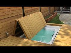 a hot tub sitting on top of a wooden deck