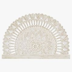 an intricately designed white wall shelf