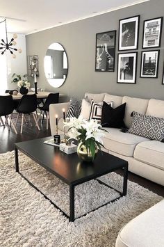 a living room filled with furniture and pictures on the wall