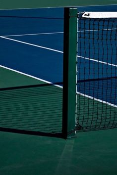 the tennis court is blue and green with white lines