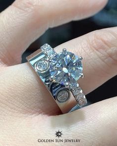 a woman's hand with a diamond ring on it