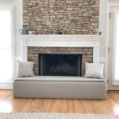 a living room with a couch and fireplace