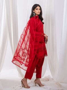 Stand out in this elegant outfit, meticulously crafted from a remarkably glamourous shade of red with its intricate hand-crafted details, with intricate embroidery on the dupatta intertwines with the fabric, forming floral motifs strikes the perfect balance between elegant and eye-catching, making this beautiful design a must have. Shirt: Self JacquardPants: Self JacquardDupatta: Organza Elegant Cambric Sharara With Traditional Drape, Elegant Red Chanderi Lawn Suit, Bollywood Red Lawn Suit For Wedding, Red Georgette Salwar Kameez For Formal Occasions, Formal Red Georgette Salwar Kameez, Formal Red Salwar Kameez With Traditional Drape, Elegant Red Unstitched Suit With Intricate Embroidery, Elegant Red Silk Lawn Suit, Elegant Red Lawn Suit For Diwali