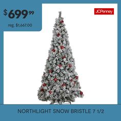 a white christmas tree with red balls on it and the price is $ 699 00