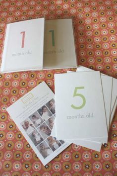 four books are laying on top of a bed with an orange and white pattern behind them