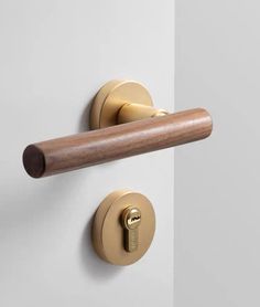 the door handle is brass and has a wooden stick on it