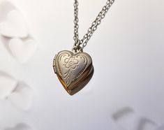 "A tiny silver heart locket hangs from a silver chain. Please select a length from the drop-down box. The necklaces's length in the last picture is 17 and 19 inches. The locket measures 1/2\" x 1/2\". *We do not personalize nor insert pictures. The locket and chain are rhodium plated over brass, so it's recommended removing before showering, swimming, etc. to keep jewelry looking like new." Locket Tattoos, Silver Heart Locket, Minimalist Necklace Gold, Silver Locket Necklace, Puffy Heart Charms, Picture Locket, Heart Locket Necklace, Locket Charms, Silver Heart Necklace