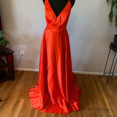 Red (It Has An Orange Tint To It) Evening Gown. Brand New Never Worn. Red Homecoming Gown, Red Floor-length Homecoming Gown, Red Floor-length Gown For Homecoming, Red Satin V-neck Gown, Red A-line Maxi Dress For Prom, Red Satin A-line Maxi Dress, Red Sweep Train Dress For Homecoming, Elegant Red Gown For Homecoming, Red V-neck Maxi Dress For Prom Season