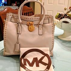 Oooo.....Something About A Cream Colored Handbag With Gold Details That Is So Dreamy. I Have Here A Michael Kors Hamilton Vanilla Whipstitch (Gold) North/South Tote In Brand New Condition, Excellent, No Wear At All. The Gold Mk Locket Is Gleaming, No Tarnish. The Key Is Intact. The Interior Is Clean Always Stuffed With Tissue Paper Stored In A Dust Bag In My Closet Waiting For That Special Someone. It Truly Is Gorgeous. Not In Production Any Longer. Designer Cream Bag With Metal Hardware, Designer White Bags With Metal Hardware, Designer Beige Satchel With Metal Hardware, Designer Cream Satchel With Dust Bag, Colorful Handbags, Paper Store, North South, Michael Kors Hamilton, Gold Details