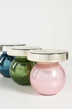 three different colored vases sitting on top of each other