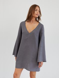 UMA is a short and flowy linen mini dress with a relaxed, slightly oversized fit. It features a deep V-neckline and 70s-inspired wide, flowing bell sleeves. DETAILS - Deep V-neckline - Wide, flowing bell sleeves - A-line silhouette - Mini length - Side seam pockets COLOR - Light Grey (featured color) - Multiple colors available in dropdown menu above - See all color options & order fabric samples here: https://www.etsy.com/listing/586569696/linen-fabric-samples SIZING & FIT - Relaxed fit - The m Dress Bell Sleeves, Linen Tunic Dress, Flare Sleeve Dress, Linen Mini Dress, Linen Tunic, Dress Tunic, 70s Inspired, Large Bust, Linen Dress