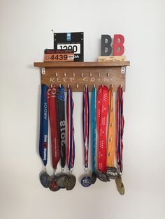 medals are hung on a shelf with the letters b and f