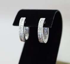 Diamond set hoop earrings in 18ct white gold A row of baguette cut diamond is set in between the rows of round cut diamond, inside and out  Hinged click closure for security Total baguette cut diamond 0.66ct Total round cut diamond 0.83ct Total Diamond Weight: 1.49cts Luxury Gia Certified Baguette Cut Earrings, Platinum Earrings With Baguette Cut Diamonds, Luxury Silver Baguette Cut Diamond Earrings, Silver Platinum Baguette Diamond Earrings, Platinum Diamond Earrings With Baguette Diamonds For Anniversary, Platinum Diamond Earrings With Baguette Diamonds In White Gold, Silver Emerald-cut Baguette Diamond Earrings, Silver Emerald Cut Diamond Earrings With Baguettes, Round Baguette Diamond Earrings