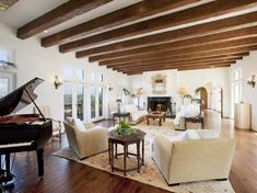 a living room filled with furniture and a grand piano