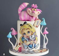 there is a cake that has been decorated to look like alice in wonderland