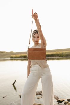 Travel far and travel often with the Nomad Crossbody. Inspired by '70s vintage, this full-grain leather beauty is the perfect piece for exploring your favorite spots in style. You’ll love its accordion-style interior and built-in wallet. Easily hold your coins and small valuables in the zipper pocket that divides the interior into two separate compartments. Plus, with its fully adjustable and removable strap, you can style the Nomad Crossbody as a clutch too. 9" wide, 6" tall, 2.5" deep Strap le Leather Travel Wallet In Cognac, Travel Wallet In Cognac With Leather Lining, Vintage Travel Wallets With Zipper Closure, Chestnut Color, Travel Purse, 70s Vintage, Leather Care, Vegetable Tanned Leather, People Around The World