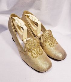 1960's gold lame' shoes with embroidered vamp and chunky heel Cute mid century modern pair of low heels. Size marked 7 B Measuresments: length ~ 9 1/2 inches, inside width ~ 2 3/4 inches, outside heel ~ 2 inches Sole reads: QualiCraft Worn 1x. These shoes are a ready to be worn! Buyer to pay all related shipping costs including insurance. Questions welcome. All Sales final Thank You CityVintage Gold Slip-on Heels For Formal Occasions, Retro Almond Toe Wedding Heels, Retro Round Toe Heels For Wedding, Gold Slip-on Heels For Wedding, Gold Slip-on Heels For Evening, Festive Round Toe Heels For Party, Gold Low Heel Holiday Heels, Gold Holiday Heels With Low Heel, Gold Low Heel Fitted Wedding Shoes