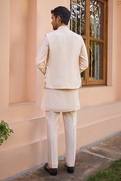 Beige bundi with marodi, dori and zardosi embroidery. Paired with a kurta and pant. - Aza Fashions Ceremonial Nehru Jacket With Gota Work For Eid, Formal Nehru Jacket With Gota Work For Diwali, Festive Nehru Jacket With Gota Work For Formal Occasions, Festive Formal Nehru Jacket With Gota Work, Fitted Nehru Jacket With Gota Work, Diwali Nehru Jacket With Chikankari Embroidery For Groom, Festive Nehru Jacket With Chikankari Embroidery For Groom, Elegant Nehru Jacket With Dori Work For Festivals, Elegant Nehru Jacket With Dori Work For Festive Season