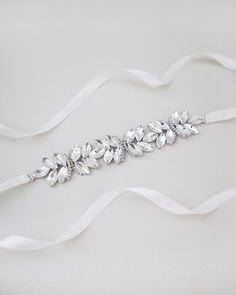 "Ethereally entangled series of butterfly rhinestones attached on bridal white double-faced satin ribbon. Creates sophisticated and romantic finishing touch to your bridal gown, bridesmaids and flower girls. This embellished sash adds a perfect amount of sparkle to create your statement look. DETAIL: Adult Size 108\" Kids Size 78\" Applique size: 7.5\" length, 1.25\" wide HANDMADE IN USA IMPORTED MATERIALS - We DO NOT offer refunds.  Selected items are eligible for EXCHANGE ONLY within 14 days of delivery date. All accessories are FINAL SALE.  - We are not responsible for lost or stolen items during transit. Additional insurance is available upon request. - Stay updated with latest news or promotion as we grow and follow us on the following outlets: Instagram:  http://instagram.com/shop.ka Elegant White Sashes With Rhinestones, White Crystal Sash For Formal Occasions, White Crystal Bridal Belt For Party, White Crystal Sashes For Formal Occasions, Elegant White Bridal Belt With Satin Bow, White Rhinestone Bridal Belt, Formal White Crystal Sash, White Satin Bridal Belt With Sashes, White Satin Bridal Belt For Party