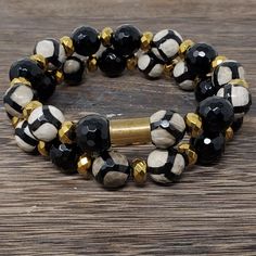 Tibetan Agate Unisex Bullet Shell Bracelet Faceted black and white Tibetan agate and faceted black onyx with gold hematite bracelet set. This is a classic color combo. Sold as a set of 2 only. Ready to ship. Perfect for last minute giving. Only 1 available. Fits approximately 7.5 - 8.5" wrist. Every item sold plants a tree through our partnership with One Tree Planted. Czech Beads Jewelry, Jean Art, African Beaded Bracelets, Swift Bracelets, Coin Charm Bracelet, African Bracelets, Bullet Shell, Diy Beaded Bracelets, Diy Jewelry Display