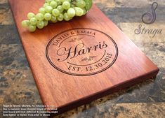 a wooden cutting board with grapes on it