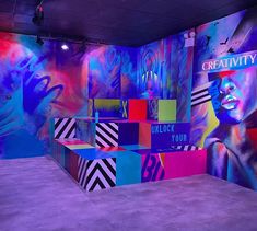 an art gallery with colorful walls and artwork on the walls, including large cubes