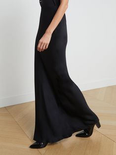 A stunning, understated maxi skirt in pure black. Bias-cut, silk-like fabric falls in a subtle, lustrous cling over the figure, enhancing and elongating the silhouette. Smooth elastic waist with no closures. | L'AGENCE Zeta Maxi Skirt In Black Evening Flared Satin Maxi Skirt, Full Length Satin Finish Maxi Dress, Elegant Wide Leg Evening Maxi Dress, Ankle-length Lined Maxi Skirt, Elegant Wide Leg Maxi Dress For Evening, Solid Ankle-length Lined Maxi Skirt, Flowy Evening Maxi Skirt, Elegant Evening Maxi Skirt In Solid Color, Ankle-length Solid Lined Maxi Skirt