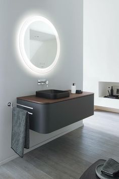 a bathroom with a sink, mirror and towel rack on the wall in front of it