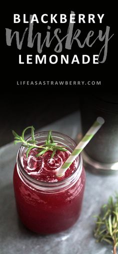 black berry whiskey lemonade in a mason jar with rosemary garnish on the rim