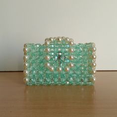 Crafted with care and meticulous attention to detail, this beautiful beaded card holder was designed with functionality and elegance in mind. Each bead is carefully arranged by me, adding a unique touch to this handcrafted accessory and setting it apart from mass-produced items. Ideal for the modern individual who appreciates the beauty of handcrafted work, this card holder is not only a practical storage solution, but also a fashion statement. Carry your essentials in style with this beaded car Elegant Green Rectangular Card Holder, Beaded Rectangular Clutch For Gift, Beaded Rectangular Clutch As Gift, Rectangular Beaded Clutch As Gift, Elegant Green Formal Card Holder, Elegant Rectangular Card Holder For Evening, Elegant Rectangular Card Holder For Gift, Elegant Green Clutch With Card Slots, Elegant Rectangular Evening Card Holder