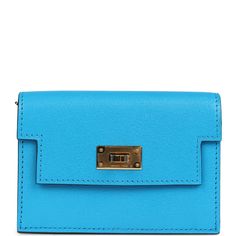 This Kelly Slim Wallet is in Bleu Frida chevre leather with gold hardware and has tonal stitching, turnlock closure and a wristlet strapThe interior is lined with Bleu Frida chevre leather and features one slip pocket on the rear wall and one pocket with a zip closure. Collection: BOrigin: FranceCondition: New and never worn (plastic on hardware)Accompanied by: Hermes box, Hermes dustbag, and feltMeasurements: 4.25" width x 3.25" width x 1" depth Monogram Neverfull, Hermes Box, Backpack Tote Bag, Handbag Wallet, Slim Wallet, Vintage Louis Vuitton, Hermes Bags, Carry All Bag, Wallet Accessories