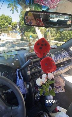 the interior of a car is decorated with red and white flowers, including ladybugs