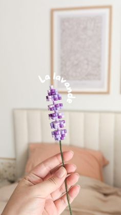 a person holding a flower in their hand with the word happy written on it,