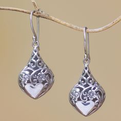 Crafted of sterling silver these dangle earrings display lovely floral openwork that is accentuated by a combination of finishes. Putu Putri presents these earrings which feature gleaming heart shapes at the bottom. Pierced Heart Drop Earrings For Mother's Day, Mother's Day Pierced Drop Heart Earrings, Mother's Day Pierced Heart Drop Earrings, Pierced Dangle Heart Earrings For Mother's Day, Silver Flower Earrings For Valentine's Day, Sterling Silver Teardrop Earrings For Mother's Day, Silver Heart Drop Earrings For Mother's Day, Mother's Day Sterling Silver Teardrop Earrings, Elegant Heart-shaped Flower Earrings For Gifts