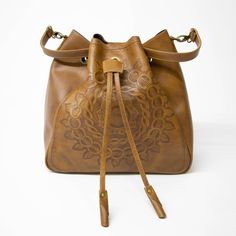 "✔ CLASSY SHOULDER BAG - BODACIOUS BUCKET BAG - elegant, supple and soft. This spacious drawstring bucket bag is hand-crafted, hand-tooled and artfully detailed with a beautiful Mandala design. Roomy construct holds all of your essentials like makeup, tablet, books, water bottle, mobile or other essentials. Stylish. Fashionable. Supple and Soft. Pair with casual clothes for daytime wear or take-along during the evening for a night out on the town with all of your essentials for a night away from Everyday Hand Tooled Crossbody Bags, Hand Tooled Crossbody Bags For Everyday, Everyday Hand-tooled Crossbody Bag, Brown Bucket Bag With Detachable Handle As Gift, Artisan Pouch Bucket Bag For Everyday Use, Artisan Bucket Bag With Adjustable Strap For Daily Use, Artisan Bucket Bag For Daily Use With Adjustable Strap, Brown Hobo Bag With Adjustable Strap As Gift, Hand Tooled Pouch Bag For Daily Use