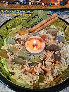 a plate filled with rice and coins on top of a table