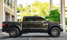 a black truck parked in front of a building