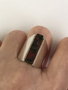 "This ring unites quiet strength with sophisticated simplicity. A rectangular agate column, just short of 1\" in length and 1/4\" wide, makes up the center of this eye catching ring. It's held in by the silver frame which starts out the same length as the stone and tapers off in the back and turns into a comfortable band. It is signed inside the band. The Henning Ulrichsen jewelry company was established in Denmark in 1951 and is still in existence and being run by the second generation. This ri Rectangular Sterling Silver Rings In Modernist Style, Contemporary Rectangular Jewelry With Polished Finish, Snake Ring, Gold Snake, Agate Ring, Charm Rings, Jewelry Companies, Amethyst Ring, Silver Frame