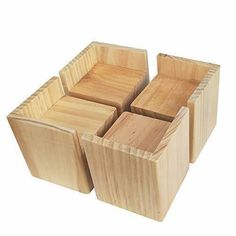 four wooden boxes are stacked on top of each other