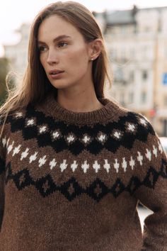 a woman wearing a brown and black sweater