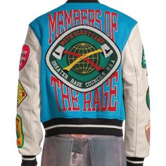 a man wearing a jacket with patches on it and the words, members of the race